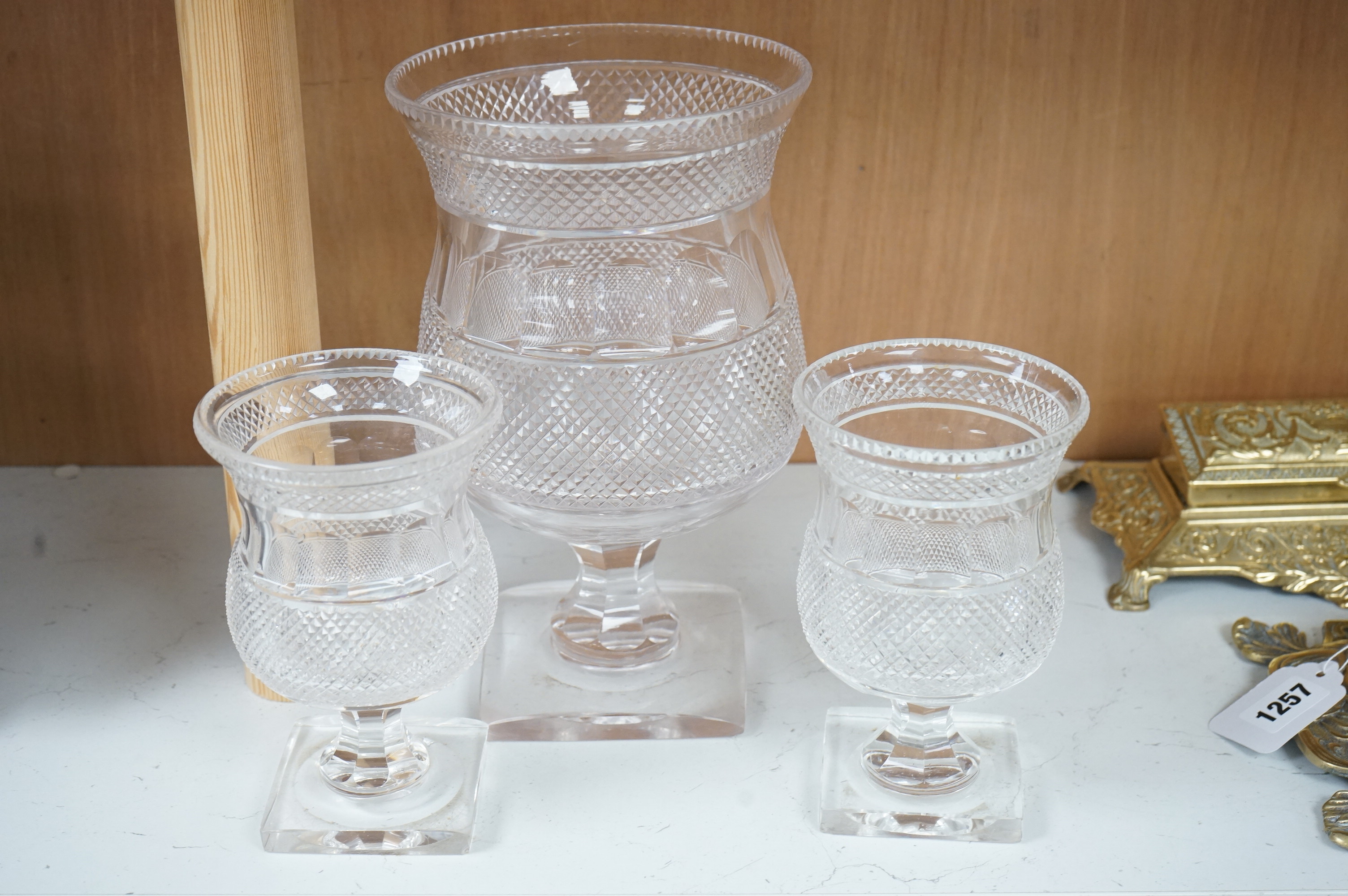 A garniture of three 19th century cut glass vases, largest 26cm high